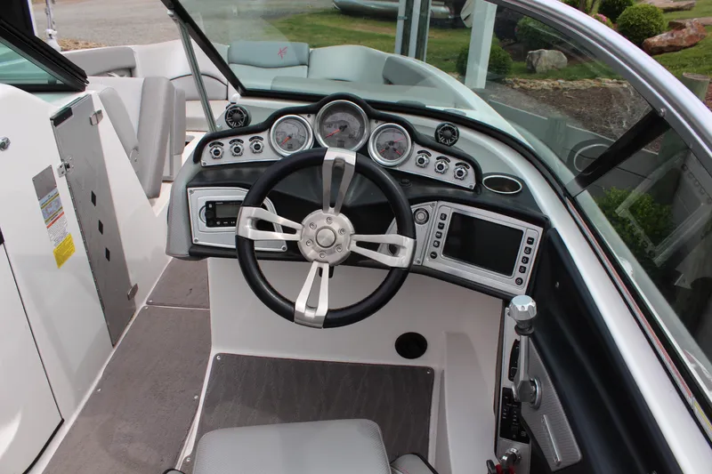 Slide: The Image of 2016 MasterCraft X26 boat dashboard with steering wheel and control panel. - 7