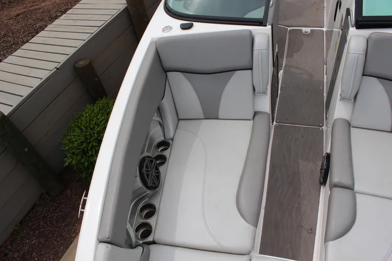 Slide: The Image of 2016 MasterCraft X26 boat interior with gray seating and cup holders. - 9