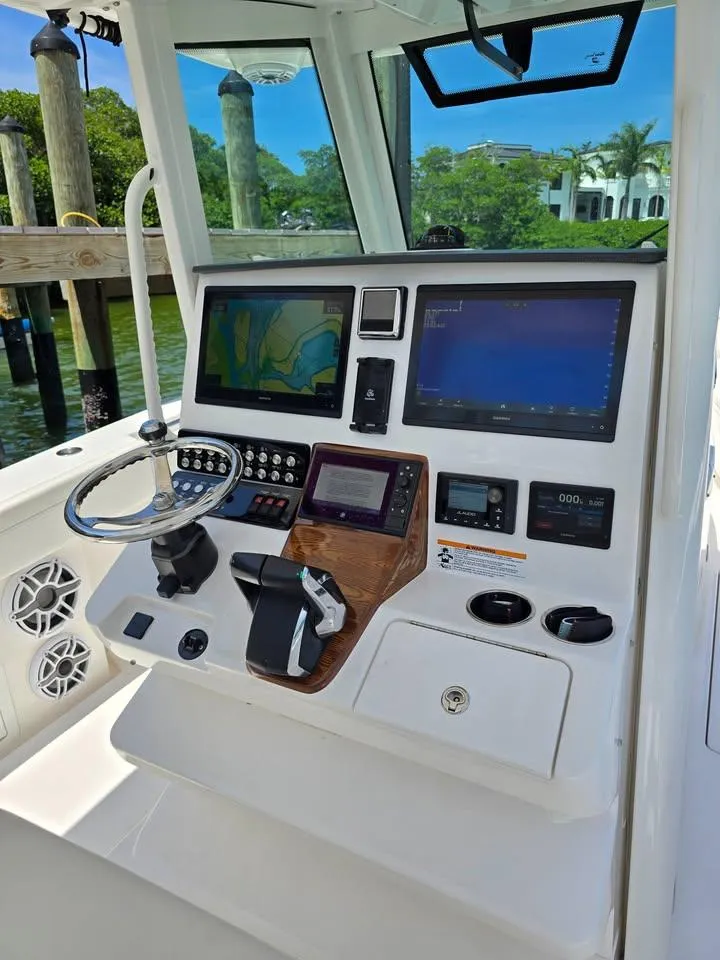 Slide: The Image of 2023 Caymas 30 CT boat dashboard with advanced navigation and control systems. - 11