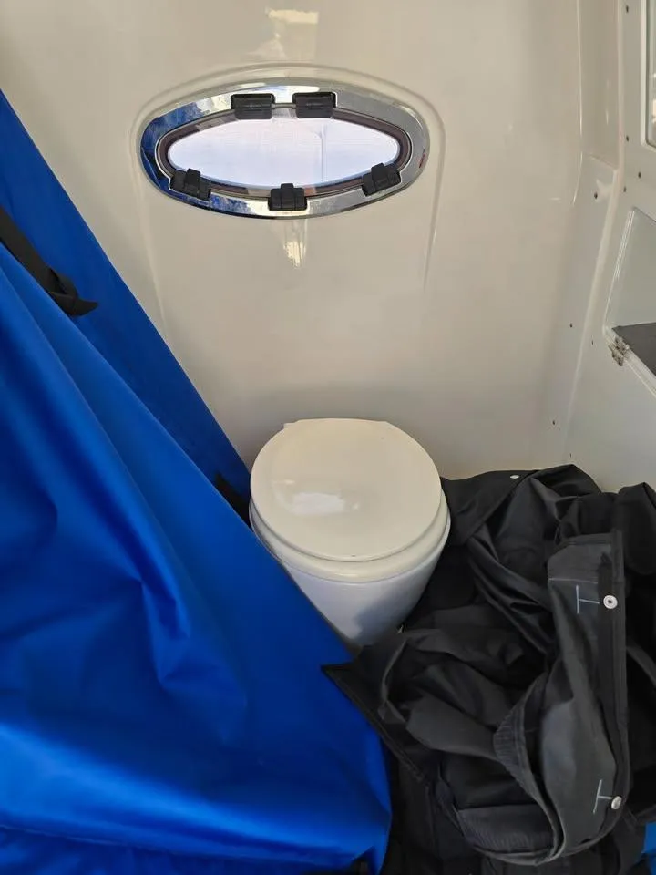 Slide: The Image of 2023 Caymas 30 CT boat interior with toilet and blue cover. - 20