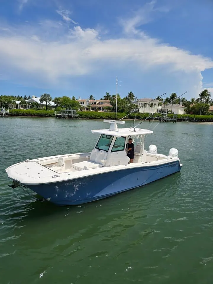 Slide: The Image of 2023 Caymas 30 CT boat on calm water with scenic background. - 6
