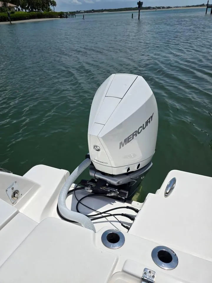 Slide: The Image of 2023 Caymas 30 CT boat with Mercury outboard motor on calm water. - 9