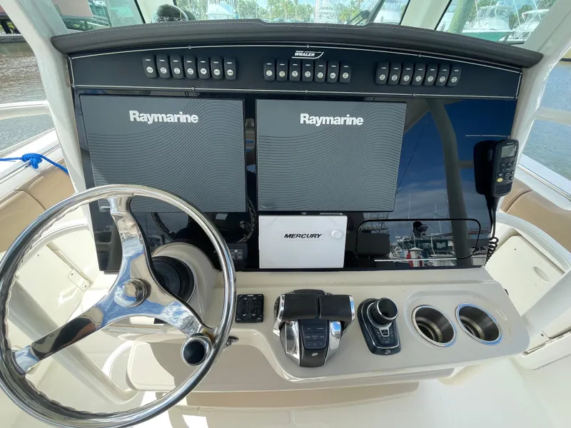 Slide: The Image of 2018 Boston Whaler 330 Outrage helm with Raymarine displays and Mercury controls. - 14