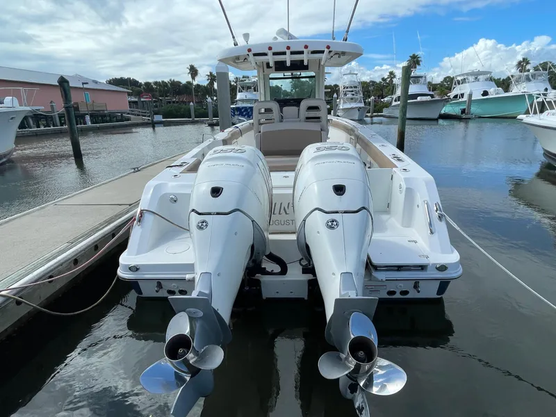 Slide: The Image of 2018 Boston Whaler 330 Outrage boat with dual engines docked at marina. - 4
