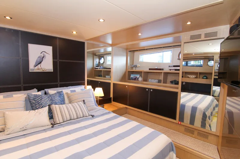 Slide: The Image of Luxurious bedroom interior of 2009 Riva 68' EGO SUPER yacht with striped bedding. - 27