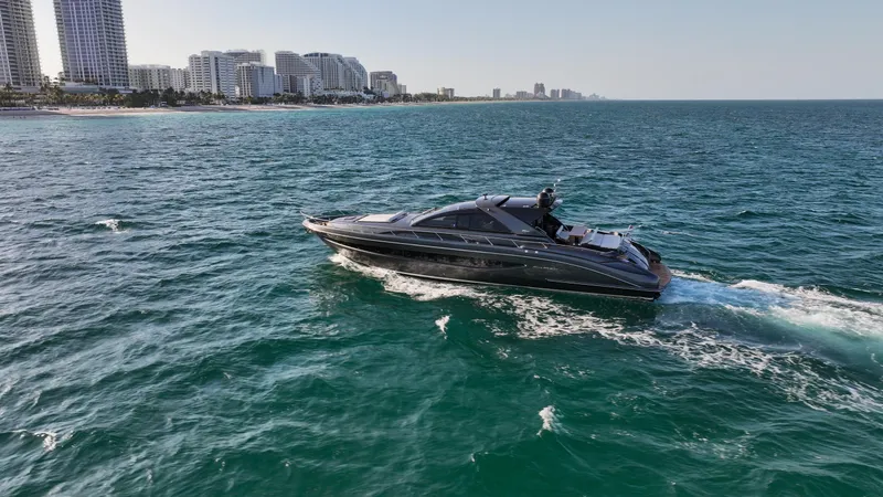 Slide: The Image of Luxurious 2009 Riva 68' EGO SUPER yacht cruising near a coastal city skyline. - 4