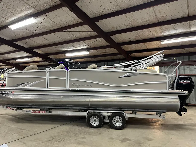 The Image of 2019 Premier 250 Solaris pontoon boat on trailer in indoor storage facility. - 1