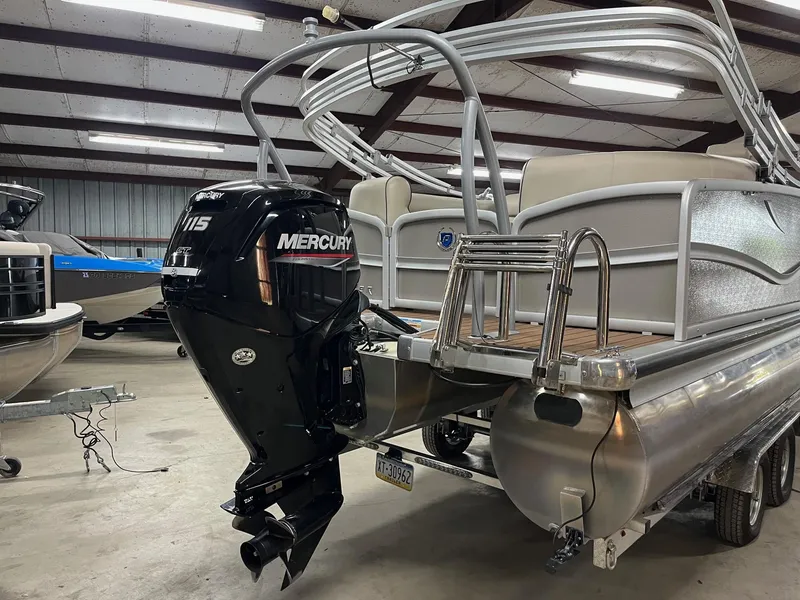Slide: The Image of 2019 Premier 250 Solaris pontoon boat with Mercury outboard motor in a storage facility. - 4