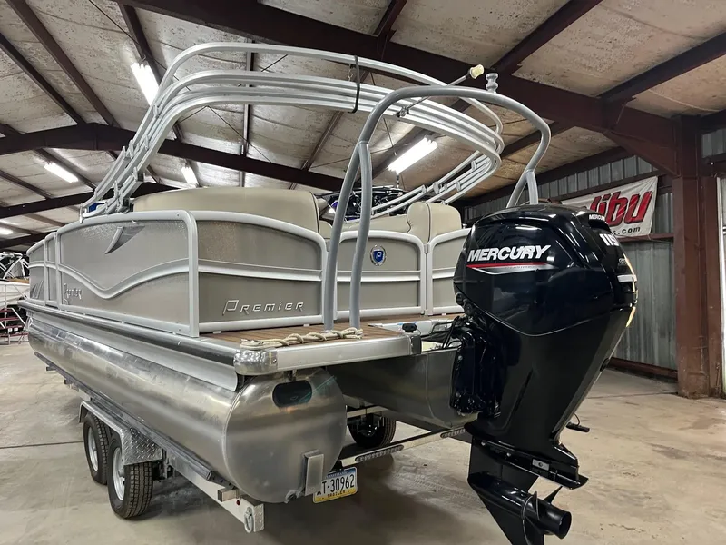 Slide: The Image of 2019 Premier 250 Solaris pontoon boat with Mercury engine in a warehouse setting. - 5