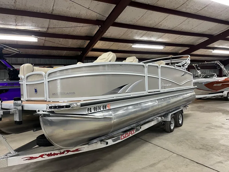 Slide: The Image of 2019 Premier 250 Solaris pontoon boat on trailer in indoor storage facility. - 6