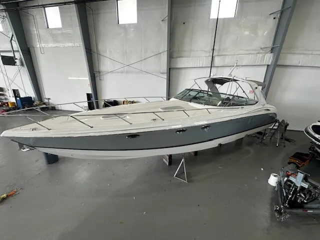 The Image of 2005 Formula 400 SS boat in a storage facility, showcasing sleek design and spacious deck. - 0