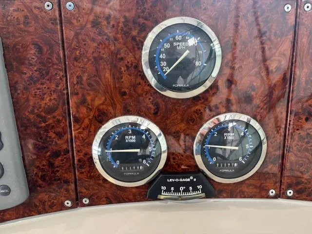 Slide: The Image of Dashboard of 2005 Formula 400 SS with speedometer and RPM gauges on wood panel. - 10