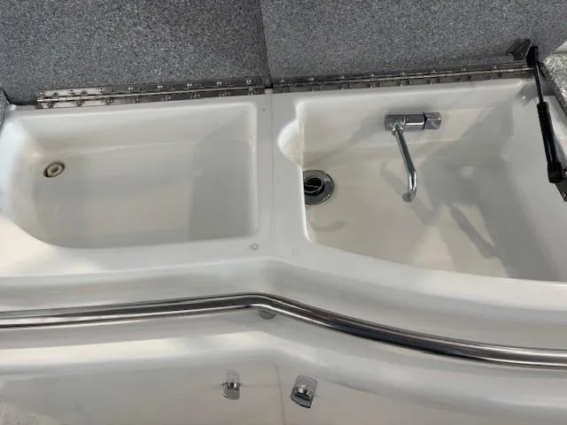 Slide: The Image of Dual sink setup in a 2005 Formula 400 SS boat, featuring stainless steel fixtures. - 7
