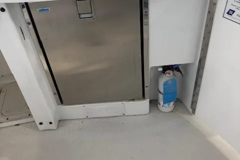 Slide: The Image of 2005 Formula 400 SS boat interior with stainless steel appliance and fire extinguisher. - 8