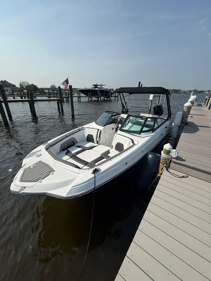 The Image of 2023 Monterey M65 boat docked by a pier on a sunny day. - 1