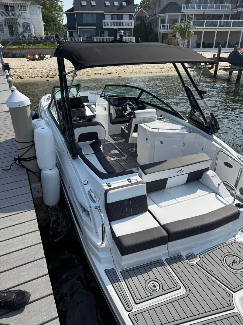Slide: The Image of 2023 Monterey M65 boat docked, featuring sleek design and spacious seating. - 11