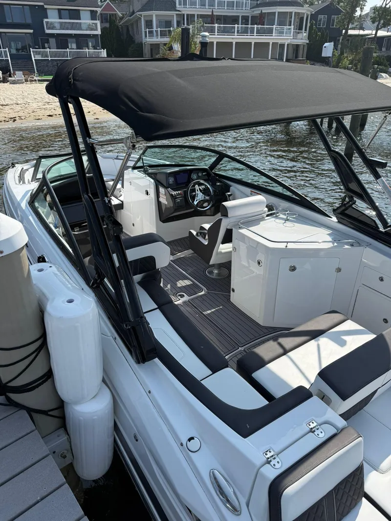 Slide: The Image of 2023 Monterey M65 boat docked, featuring sleek design and spacious seating. - 12