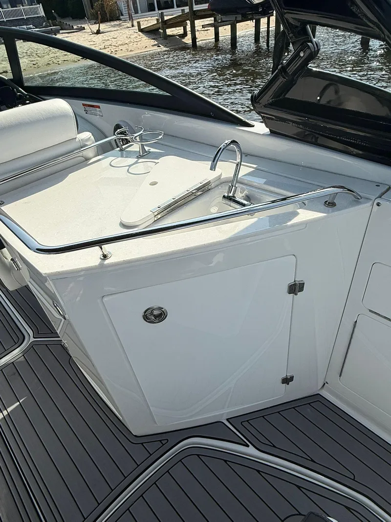 Slide: The Image of 2023 Monterey M65 boat interior with sleek white cabinetry and modern fixtures. - 16
