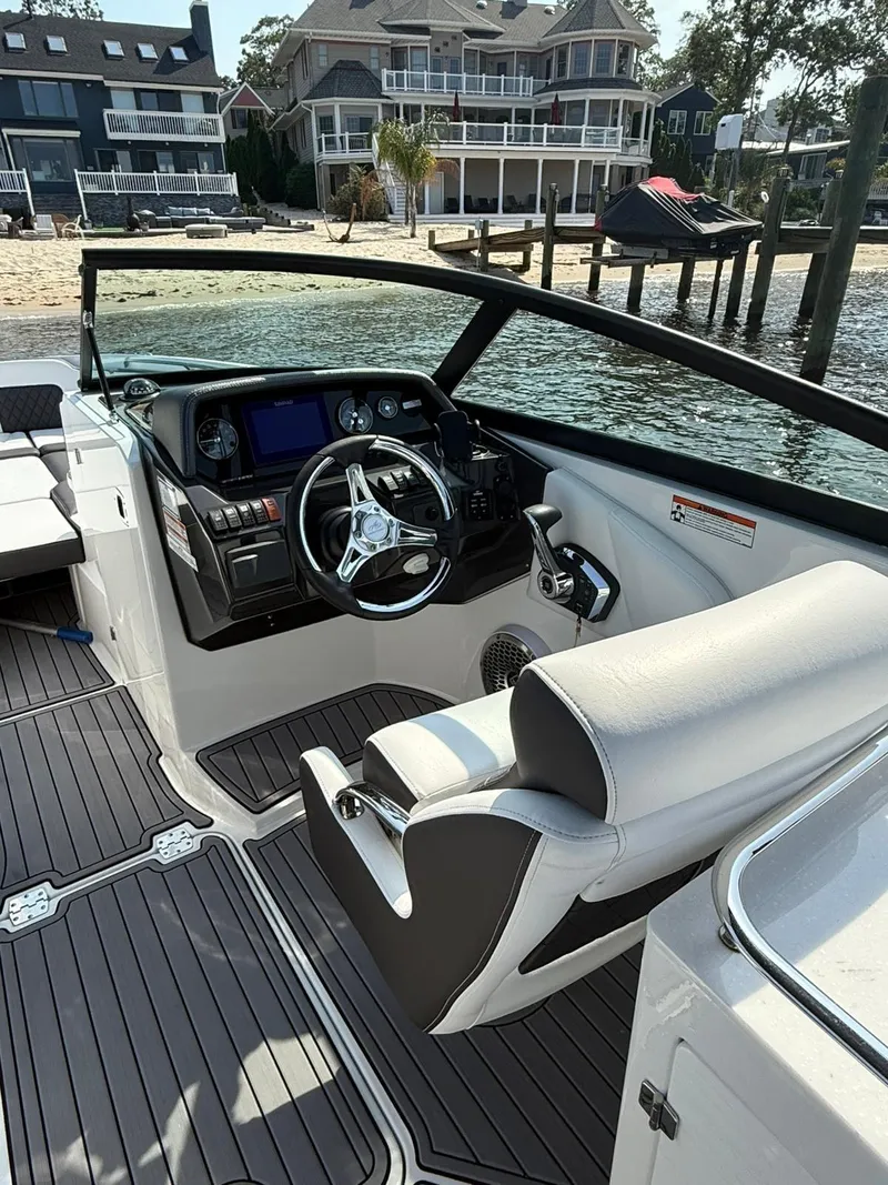 Slide: The Image of 2023 Monterey M65 boat interior with sleek dashboard and waterfront view. - 19