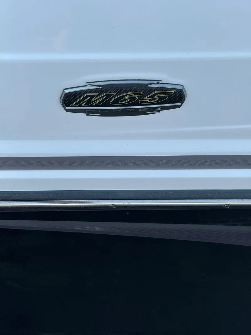 Slide: The Image of 2023 Monterey M65 boat emblem on white surface. - 21