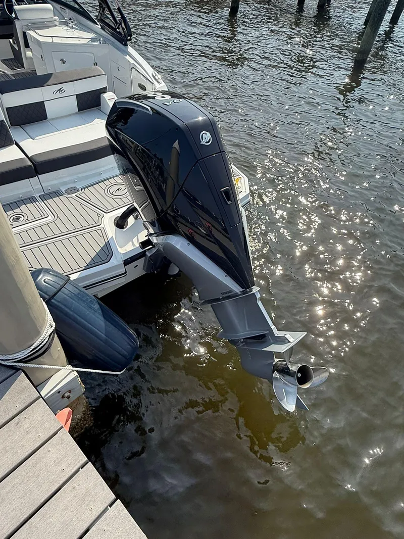 Slide: The Image of 2023 Monterey M65 boat with outboard motor docked on sunny water. - 3