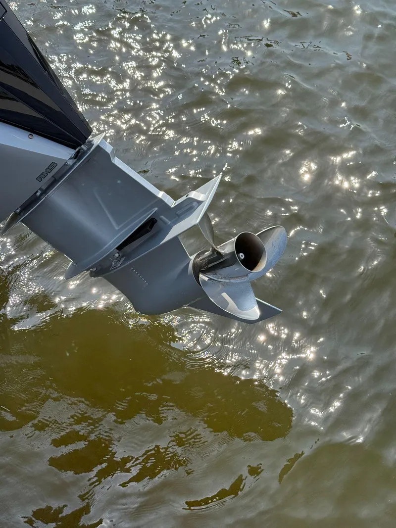 Slide: The Image of Outboard motor of 2023 Monterey M65 boat in water, reflecting sunlight. - 5