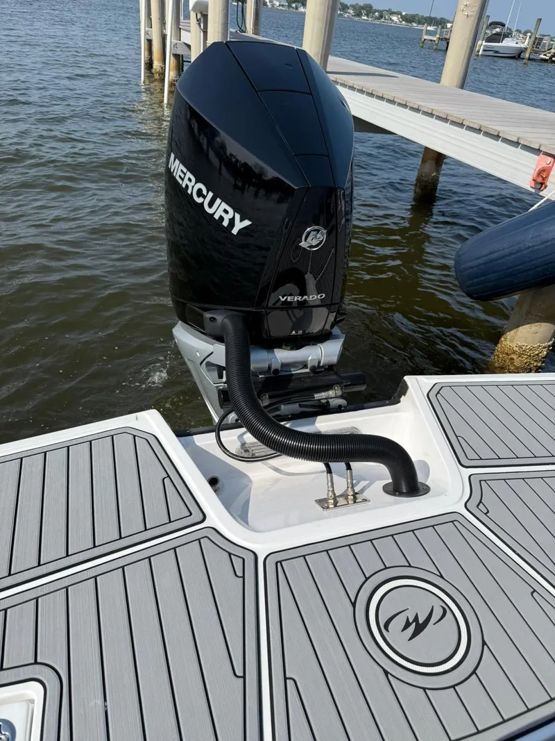 Slide: The Image of 2023 Monterey M65 boat with Mercury outboard engine, docked by the water. - 8
