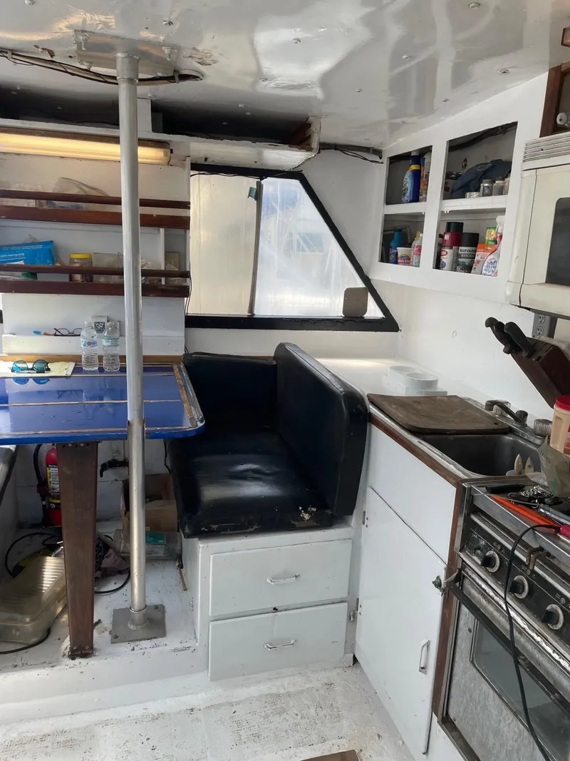 Slide: The Image of Interior of 1983 Commercial Hull #1 Key West boat with kitchen and seating area. - 14