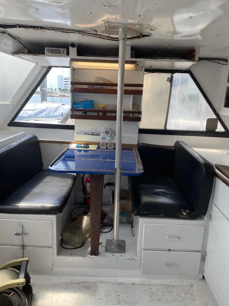 Slide: The Image of Interior of 1983 Commercial Hull #1 Key West boat with seating and table. - 15