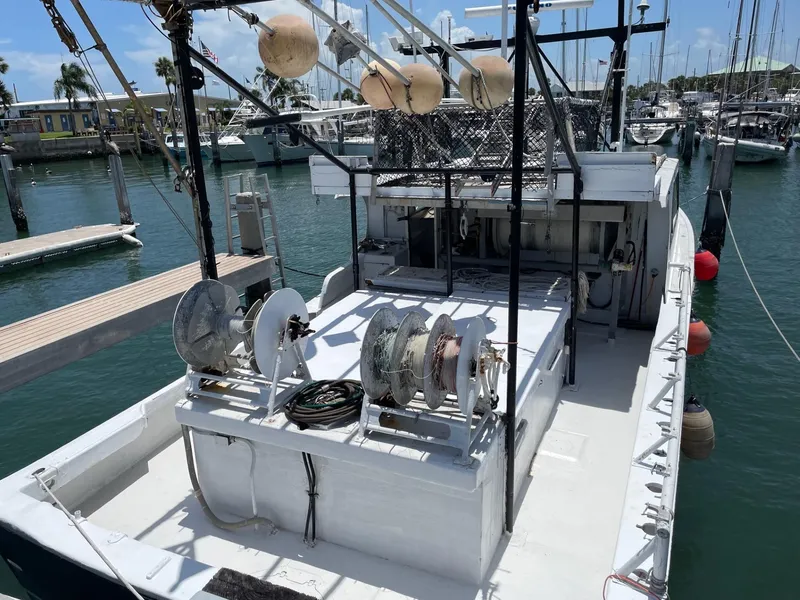 Slide: The Image of Commercial fishing boat, Hull #1 Key West, 1983, docked in marina with equipment visible. - 18