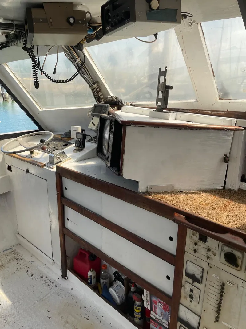 Slide: The Image of 1983 Commercial Hull #1 Key West boat interior with navigation equipment and controls. - 7