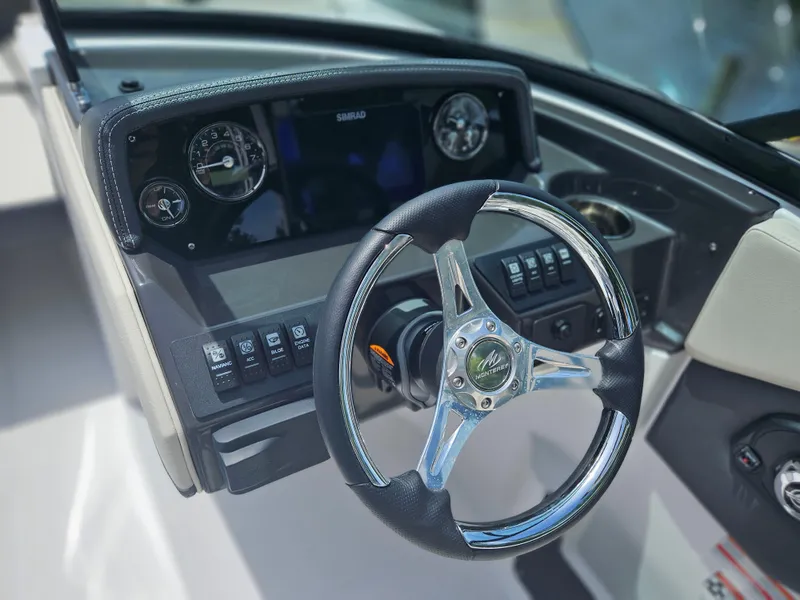 Slide: The Image of Steering wheel and dashboard of 2025 Monterey M-225 boat, featuring modern controls and gauges. - 15