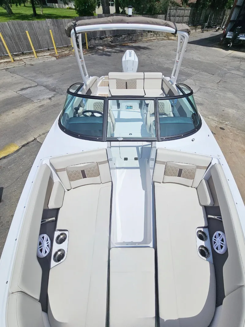 Slide: The Image of 2025 Monterey M-225 boat with spacious seating and modern design, docked outdoors. - 20