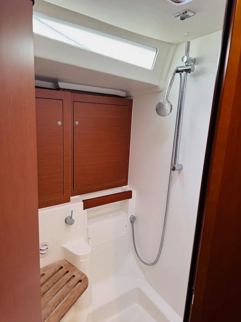 Slide: The Image of Beneteau Oceanis 51.1 2020 yacht bathroom with shower and wooden accents. - 15