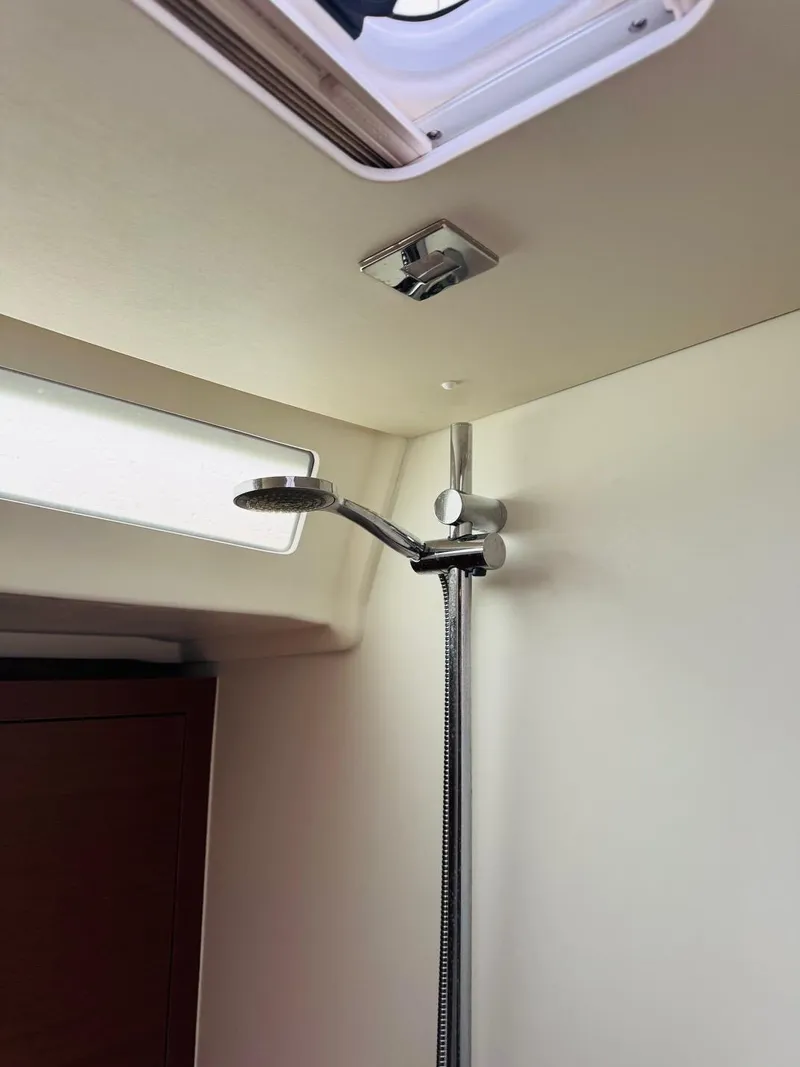 Slide: The Image of Beneteau Oceanis 51.1 2020 yacht shower area with modern fixtures and natural light. - 16