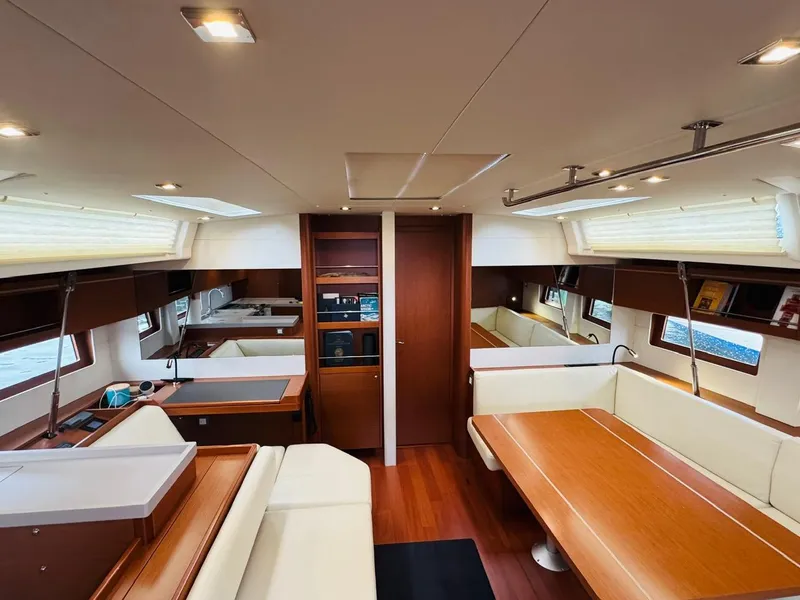 Slide: The Image of Interior of 2020 Beneteau Oceanis 51.1 yacht, featuring elegant wood finishes and spacious seating. - 20