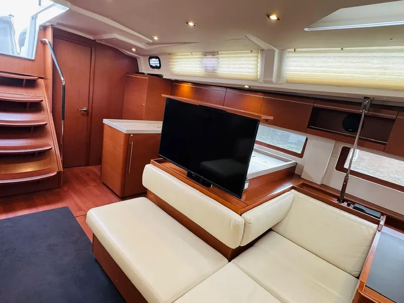 Slide: The Image of Interior of 2020 Beneteau Oceanis 51.1 yacht with modern seating and TV. - 23