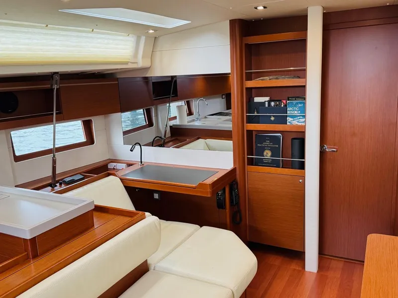 Slide: The Image of Interior of 2020 Beneteau Oceanis 51.1 yacht with modern wood finish and seating area. - 25