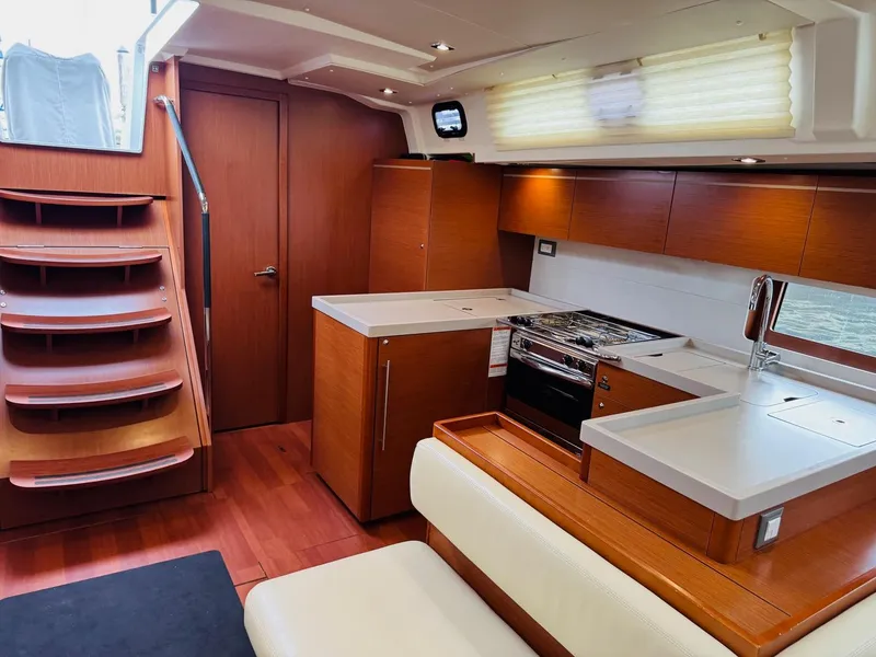 Slide: The Image of Interior of 2020 Beneteau Oceanis 51.1 yacht, featuring modern kitchen and wooden finishes. - 29