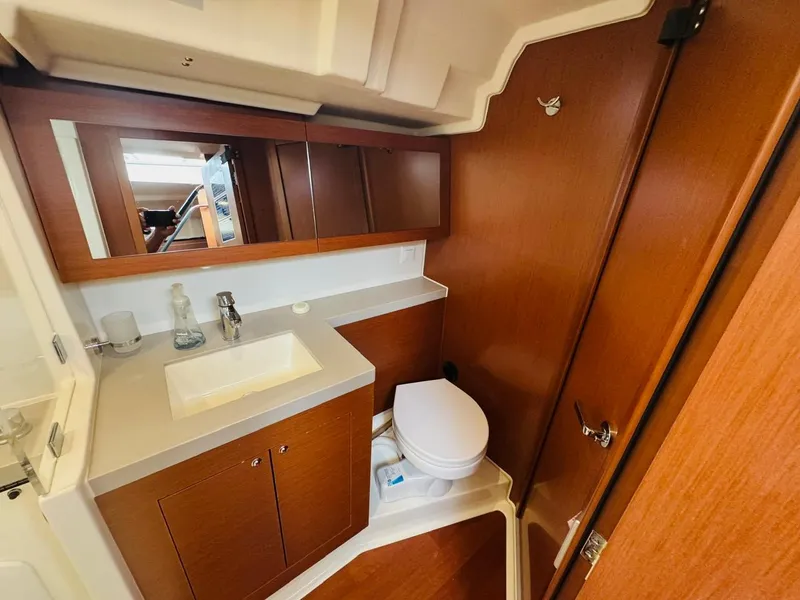 Slide: The Image of 2020 Beneteau Oceanis 51.1 yacht bathroom with wooden cabinetry and modern fixtures. - 44