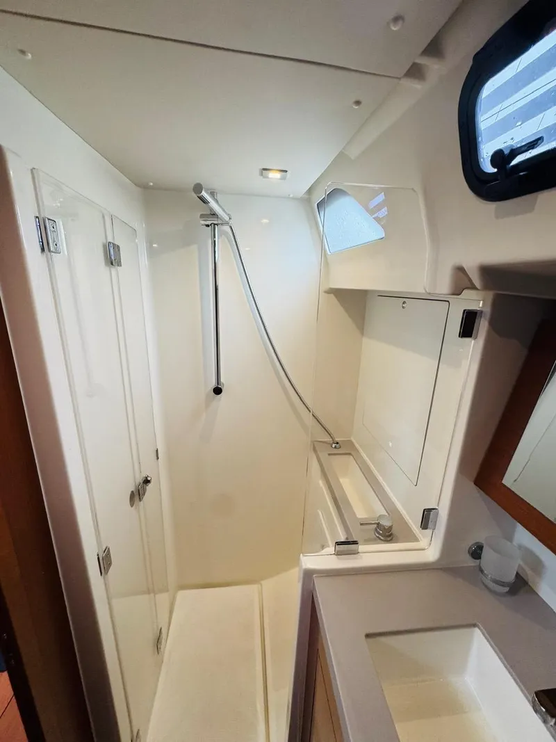 Slide: The Image of Beneteau Oceanis 51.1 2020 yacht bathroom with shower, sink, and mirror. - 45
