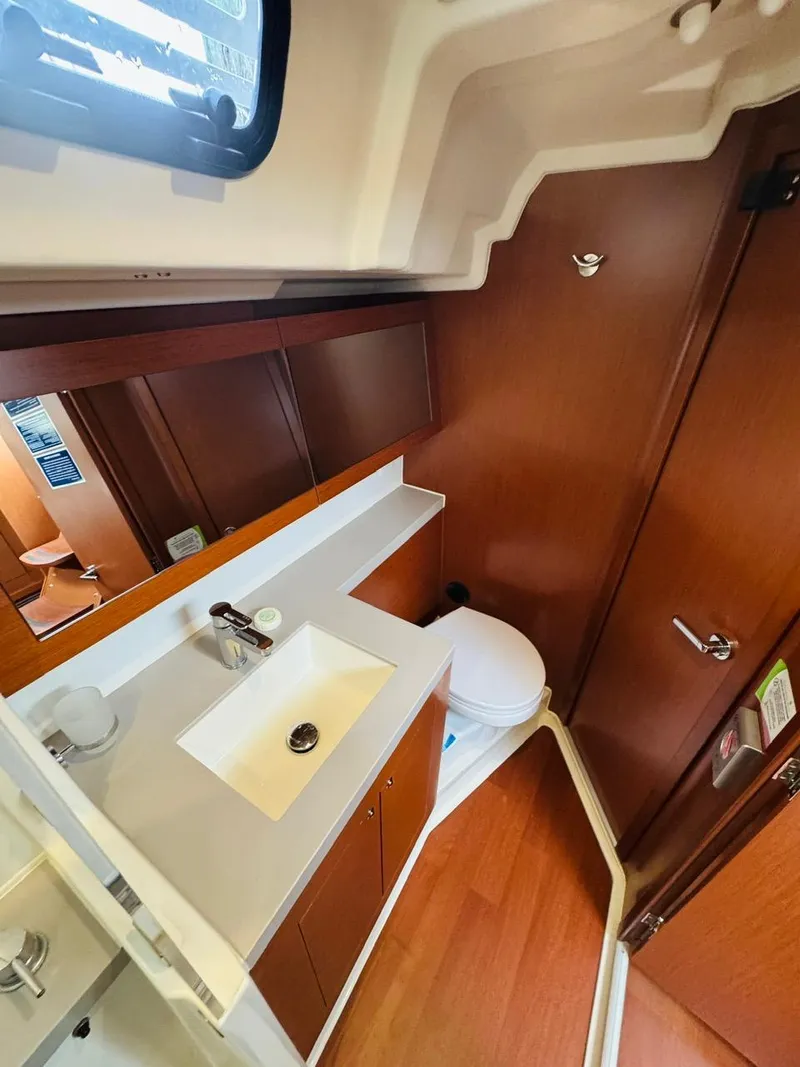 Slide: The Image of Beneteau Oceanis 51.1 2020 yacht bathroom with modern sink and wooden cabinetry. - 46