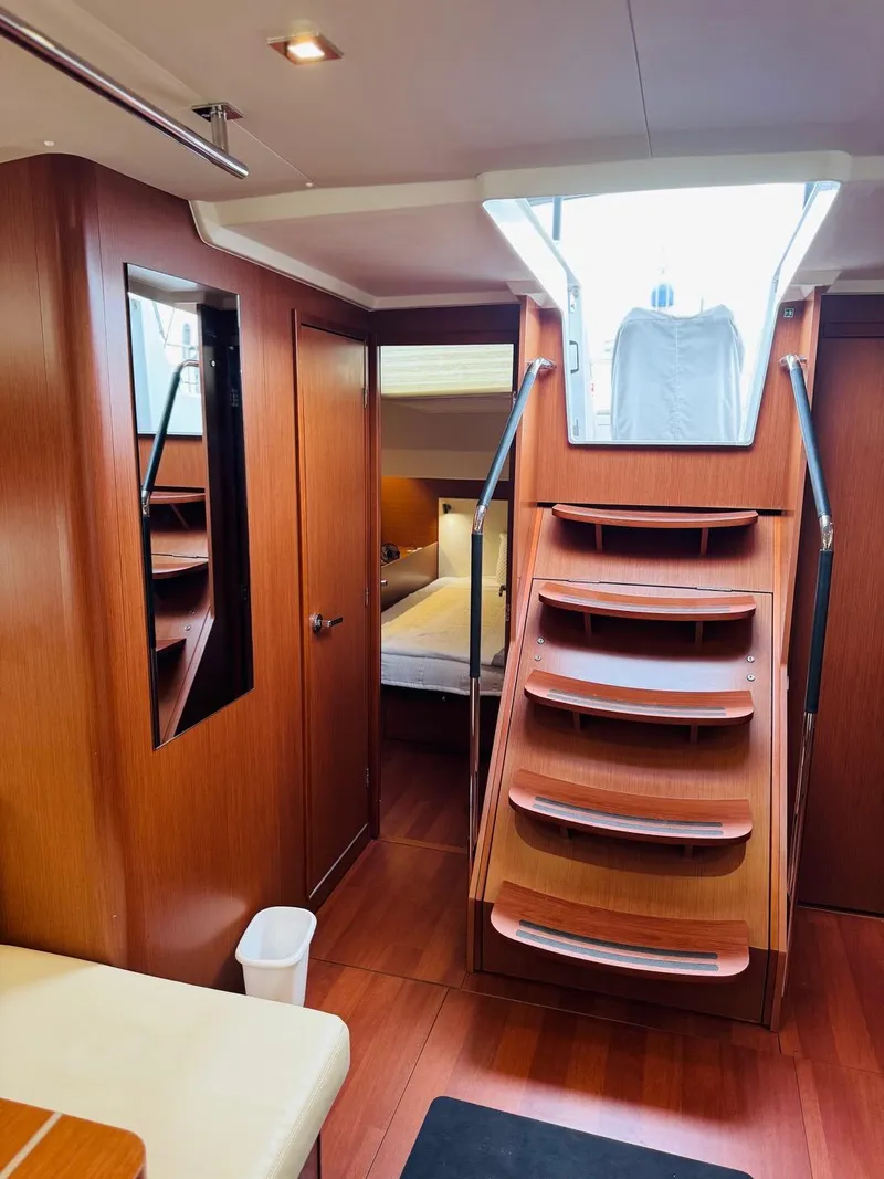 Slide: The Image of Interior of 2020 Beneteau Oceanis 51.1 yacht with wooden stairs and cozy cabin. - 47