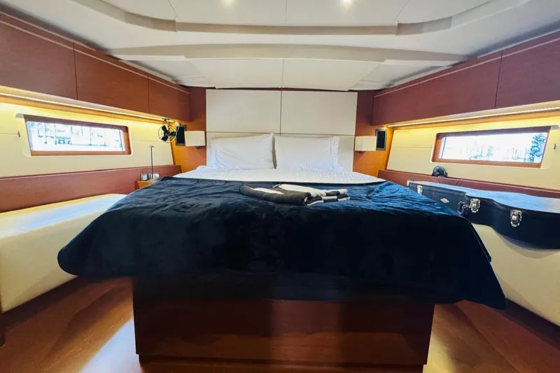Slide: The Image of Luxurious cabin interior of 2020 Beneteau Oceanis 51.1 yacht with elegant bedding and wood accents. - 9