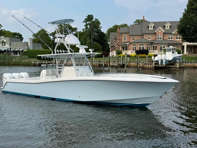 The Image of 2016 Invincible 39 Open Fisherman boat docked near waterfront homes. - 0