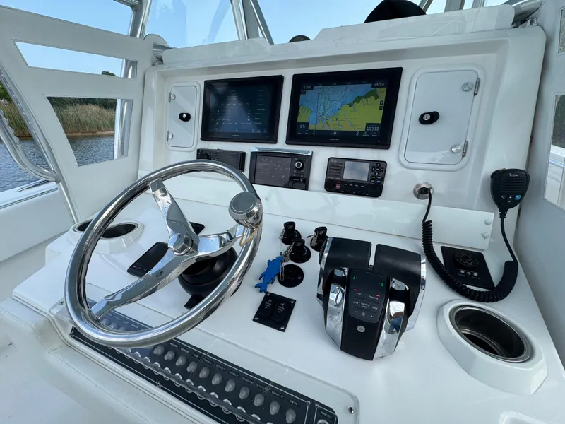 Slide: The Image of Control panel of a 2016 Invincible 39 Open Fisherman boat with navigation screens. - 12