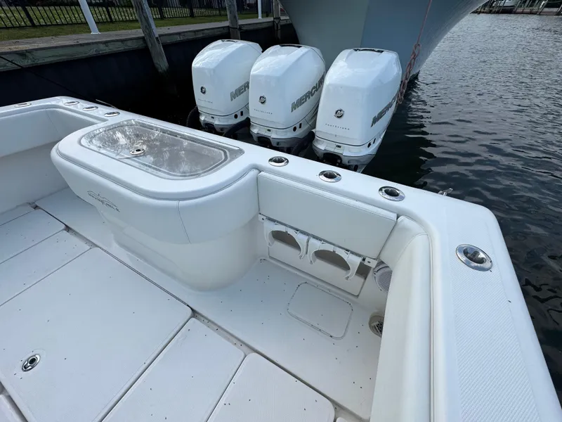 Slide: The Image of 2016 Invincible 39 Open Fisherman boat with triple Mercury engines docked by the water. - 15