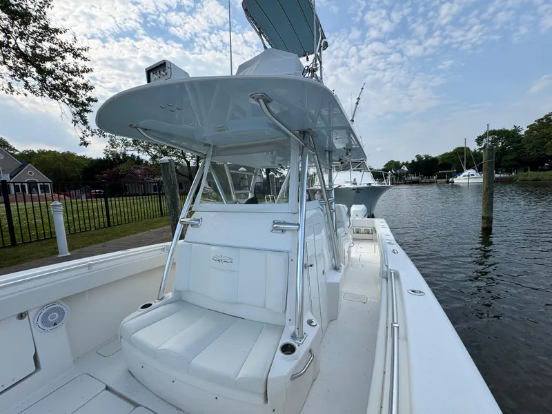 Slide: The Image of 2016 Invincible 39 Open Fisherman boat docked by a serene waterfront. - 16