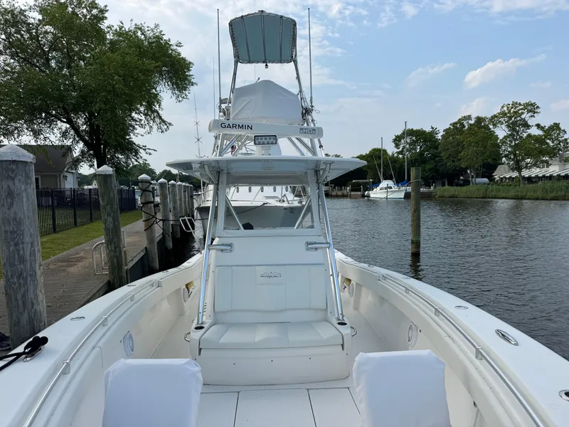 Slide: The Image of 2016 Invincible 39 Open Fisherman boat docked by a serene waterfront. - 18