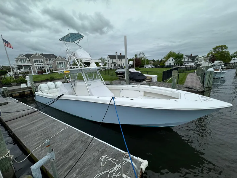 Slide: The Image of 2016 Invincible 39 Open Fisherman docked near waterfront homes. - 21